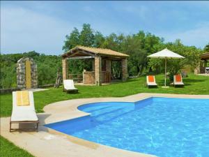 a swimming pool with a gazebo and chairs at Scenic Villa in Paleokastrites with Sauna in Gouvia