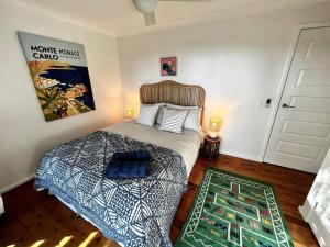 a bedroom with a bed and a door with a rug at The Treehouse at Copa in Copacabana