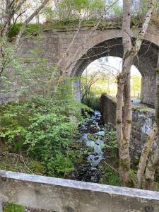 a stone bridge over a river with at Perfect for country lovers in Grantown on Spey