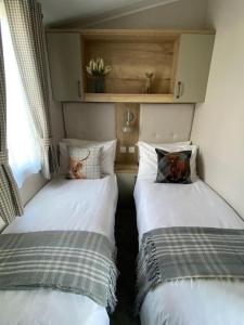 two twin beds in a room with a window at Perfect for country lovers in Grantown on Spey