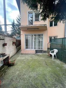 a house with a white chair in front of it at Private house - outdoor barbecue in Sarajevo