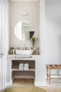 a bathroom with a sink and a mirror at Paternoster Dunes Boutique Guesthouse in Paternoster