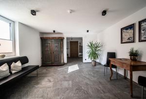 a living room with a couch and a table at Appartements Tyrol in Pettneu am Arlberg