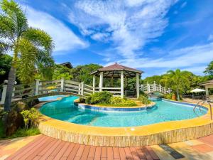 a pool at a resort with a gazebo at La Jolla Hotel and Beach Resort in Malawin