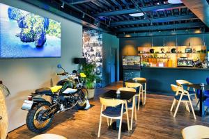 a motorcycle parked in a restaurant with tables and chairs at SINATRA CIGAR HOUSE in Banská Bystrica