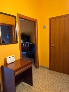 a room with a desk and a mirror and a door at Scalea City Center Apartments in Scalea +28 photos