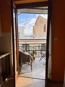 an open door to a balcony with a view of a building at Scalea City Center Apartments in Scalea
