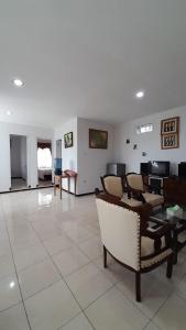 a living room with chairs and a table and a couch at In Villa Garden Resort in Batu