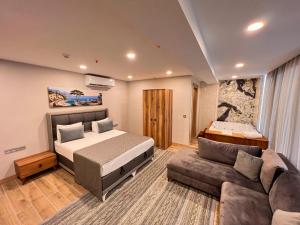 a bedroom with a bed and a couch at Old Town Point Hotel & Spa Antalya in Antalya