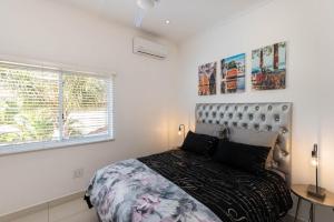 a bedroom with a large bed and a window at Bayridge 48 ~ Penthouse in Ballito