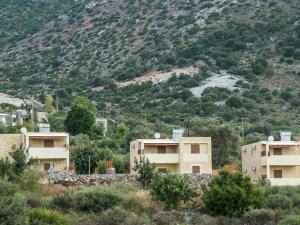 a group of houses in front of a mountain at Luxurious Villa in Bali Crete with Pool in Balíon