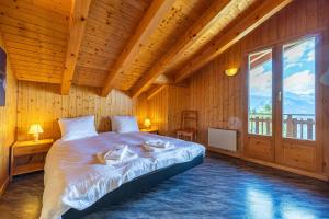 a bedroom with a large bed in a wooden room at Les 2 Sabots in Nendaz