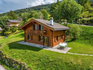a small wooden house with a bench in a yard at Les 2 Sabots in Nendaz