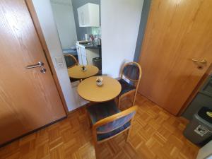 a small room with two tables and chairs and a kitchen at ABM Apartment Haus in Zwingenberg