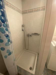 a small bathroom with a shower with a sink at Anastasia's Seaview apartment in Hanioti
