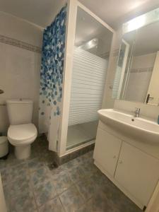 a bathroom with a toilet and a sink at Anastasia's Seaview apartment in Hanioti