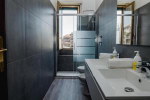 a bathroom with a sink and a toilet and a window at ShortMi Balilla in Milan