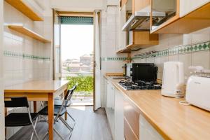 a kitchen with a counter and a table and a window at ShortMi Balilla in Milan +37 photos
