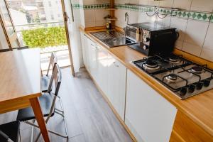 a small kitchen with a stove and a microwave at ShortMi Balilla in Milan