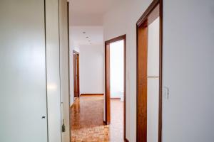 a hallway with two doors and a tile floor at ShortMi Balilla in Milan