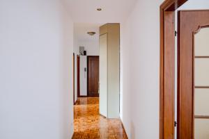 a hallway with white walls and a brick floor at ShortMi Balilla in Milan