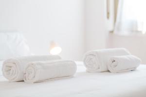 a pile of towels sitting on a bathroom counter at ShortMi Balilla in Milan