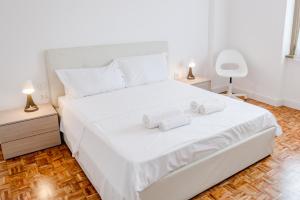 a bedroom with a large white bed with towels on it at ShortMi Balilla in Milan