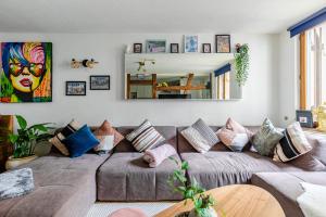 salon z brązową kanapą z poduszkami w obiekcie * Loft 3 pièces/Calme, tout équipé @ Centre Ville w Strasburgu