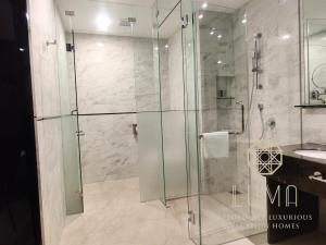a glass shower in a bathroom with a sink at The Platinum 2 Kuala Lumpur by LUMA in Kuala Lumpur