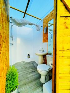 a bathroom with a toilet and a sink at CAYORETREAT LUXURY BELL TENT in Clodock