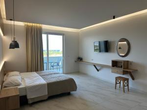 a bedroom with a bed and a mirror and a window at Faliraki Star in Faliraki