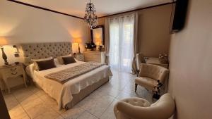 a bedroom with a large bed and a chair at Chez Virginie in Porto-Vecchio