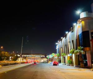 a city street at night with cars on the road at فندق لافيرا ان- الرويبح Lavera in Hotel- Rowibeh in Riyadh