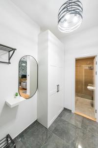 a bathroom with a mirror and a white cabinet at VERTIGO One Bedroom apartment - Free private parking-Fast WI-FI in Novi Sad