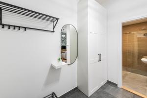 a bathroom with a mirror and a sink at VERTIGO One Bedroom apartment - Free private parking-Fast WI-FI in Novi Sad