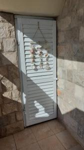 a door with pairs of shoes hanging on a wall at Apartman Copacabana in Krašići