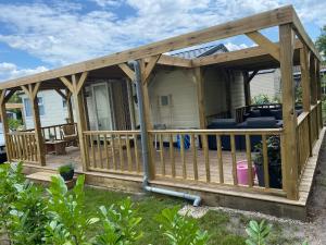 a wooden deck with awning on a house at Chalet Olm 29 in Zoerte