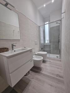 a white bathroom with a toilet and a sink at La Presentosa Bed&Breakfast in Ortona