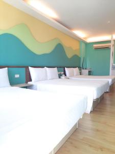 Voodi või voodid majutusasutuse 墾丁大街 皇佳旅店 toas