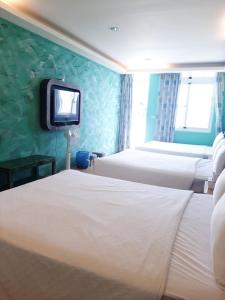 Voodi või voodid majutusasutuse 墾丁大街 皇佳旅店 toas