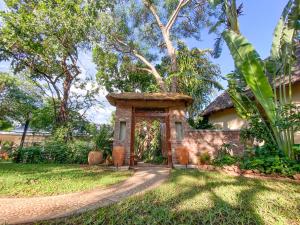 a gate to a house in a yard at Drift Inn in Victoria Falls