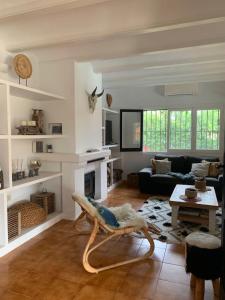 a living room with a couch and a table at La Finca Blanca Javea in El Tosalet