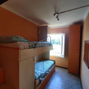two bunk beds in a room with a window at Da Luca e Simona in Camaiore +20 photos