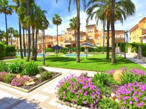 a resort with palm trees and flowers in a park at Casa Altamar I Javea - 5009 in Jávea