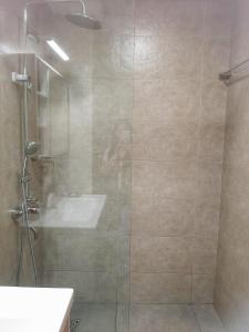 a bathroom with a shower and a sink at Cozy Apartment in Jumeirah Village Circle, Dubai. in Dubai