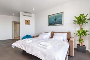 a bedroom with a large bed with two towels on it at Nest Apartment in Split