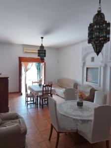 a living room with a table and chairs at Chalet Mojácar Mícar 41 in Mojácar