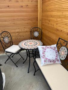 a patio with a table and two chairs and a table and chairs sidx sidx sidx at Apartmán Ivona in Štípa