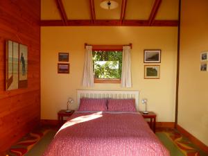 a bedroom with a bed and a window at The Old Slaughterhouse Traveller's Lodge in Hector