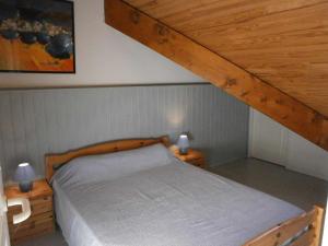 a bedroom with a wooden bed with two night stands at Appartement Saint-Lary-Soulan, 3 pièces, 6 personnes - FR-1-457-130 in Saint-Lary-Soulan